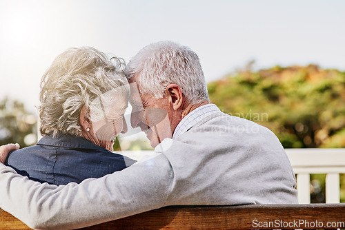 Image of Senior couple, bonding and hug or relaxing together outdoors or romantic retirement and park bench. Elderly, partners and affectionate or in love or date and feeling care for pension or garden