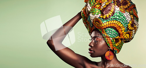 Image of Makeup, fashion and black woman in head wrap in studio for culture, glow and cosmetics on green background with space. Beauty, skincare and african female model with pride, tradition and confidence