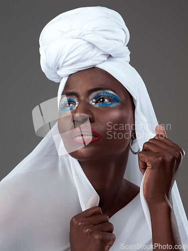 Image of Art, culture and black woman with traditional clothes and makeup isolated on studio background. Fashion, looking away and an African model with creative cultural clothing and cosmetics for confidence