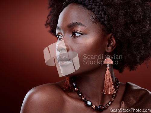 Image of Natural, beauty and black woman in studio with glowing skin on gradient, maroon or red background. Face, body care and African lady model with culture, pride and cosmetic or isolated art aesthetic