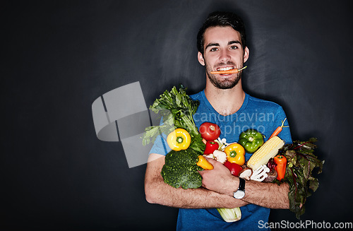 Image of Healthy, portrait of young man with vegetables and in black background. Vegan lifestyle or nutrition, food for a diet and male person isolated in studio backdrop with groceries or ingredients