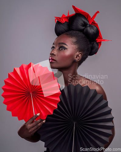 Image of Cosmetics, makeup and origami with black woman in studio for creative, art and culture. Traditional, beauty and paper design with female model and fans on grey background for asian, retro or color