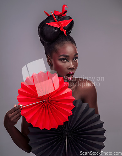 Image of Shocked, makeup and beauty with portrait of black woman in studio for creative, art and culture. Traditional, cosmetics and paper design with model on grey background for fashion, origami or color