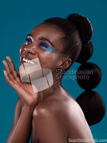 Image of Thinking, happy and makeup with a model black woman in studio on a blue background for hair or cosmetics. Face, idea and fashion with an attractive young female person posing for cosmetic beauty