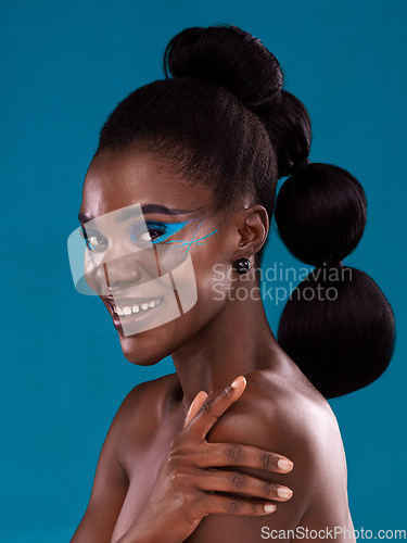 Image of Portrait, happy and makeup with a model black woman in studio on a blue background for hair or cosmetics. Face, smile and fashion with an attractive young female person posing for cosmetic beauty