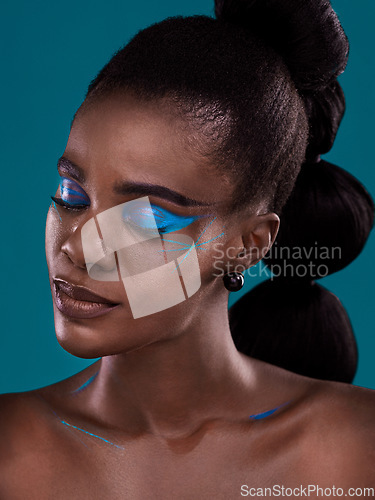 Image of Face, beauty and makeup with a black woman closeup in studio on a blue background for hair or fashion. Eyes closed, cosmetics and haircare with an attractive young female model posing for haircare