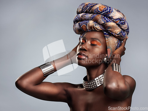 Image of Black woman in traditional turban, fashion and beauty with makeup isolated on studio background. Natural cosmetics, confidence and female model with African head wrap, cosmetic glow and style