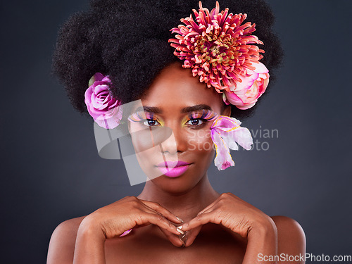 Image of Makeup, flowers and portrait of black woman in studio for beauty, creative and spring. Natural, cosmetics and floral with african model isolated on black background for color, self love or confidence