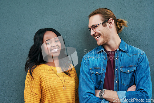 Image of Love, portrait and happy couple laughing against a wall background, bonding and having fun. Interracial relationship, smile and african woman with man outdoors relax and enjoying date or conversation