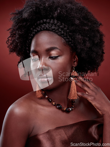 Image of Beauty, natural skin and black woman in studio with glow on gradient, maroon or red background. Face, makeup and African lady model with culture, pride or cosmetic, isolated or style and aesthetic