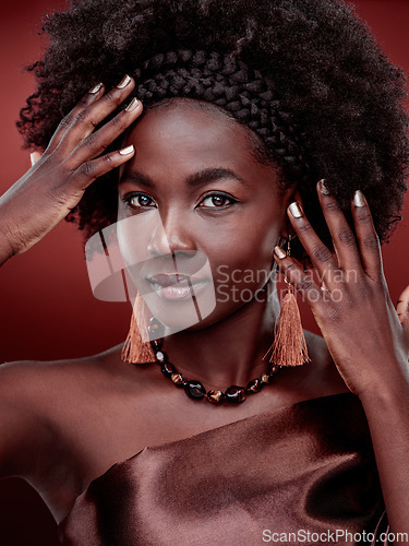 Image of Portrait, beauty and black woman with fashion in studio isolated on a red background. Natural face, makeup cosmetics and confident African model with stylish outfit, traditional headband or aesthetic