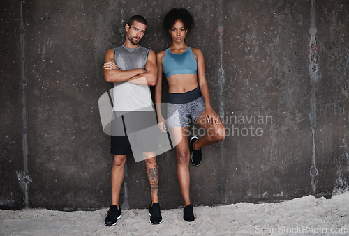 Image of Fitness, serious and portrait of couple at wall for workout, body builder training and exercise outdoors. Sports, athletes and man and woman after running for endurance, wellness and health