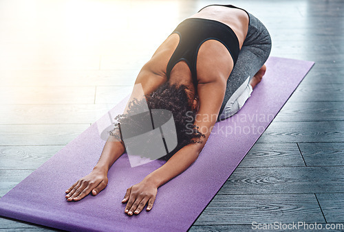 Image of Yoga, workout and wellness with a woman in studio on an exercise mat for inner peace or to relax. Health, fitness and zen with a female athlete or yogi in the childs pose for balance or mindfulness