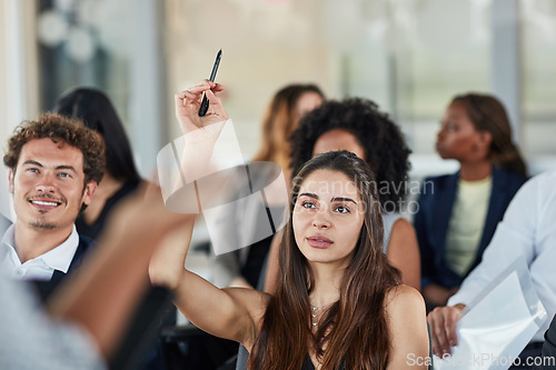 Image of Business woman, hand up and questions at seminar, conference or meeting. Audience, female person and hands raised for question, asking or answer, crowd vote and training at workshop presentation.