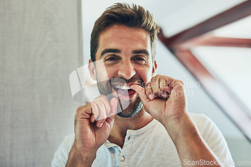 Image of Dental floss, portrait and teeth with man in bathroom mirror for cleaning, morning routine and oral hygiene. Smile, cosmetics and health with person flossing at home for self care, breath and mouth