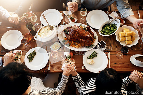 Image of Food, holding hands and people praying together at table to celebrate holiday, Christmas or thanksgiving. Above family or friends group prayer for gratitude, chicken or turkey for lunch or dinner