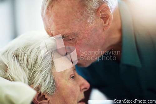 Image of Senior, kiss and couple in hospital for healthcare, visiting sick patient and hope for recovery. Clinic, elderly man and woman kissing on forehead with love, care and empathy, kindness and comfort.