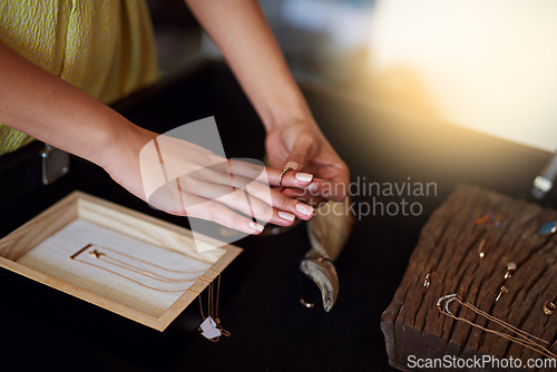 Image of woman, hands and shopping for a ring at a jewellery store for fashion, luxury accessory and fun. Female person or customer in a retail shop for choice, offer or sale on jewelry product on a counter