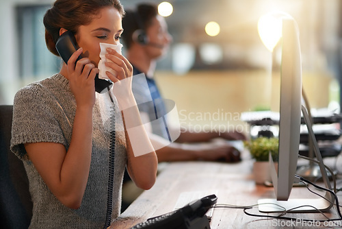 Image of Sick, phone call and a woman blowing nose for allergies, virus or flu while at work. Contact, business and a young female employee talking on a telephone with a disease, covid or allergy in an office