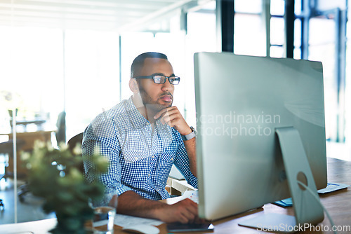 Image of Business man, thinking and computer at desk in office for online research, reading email or report. Male entrepreneur person with internet connection for feedback, review and focus on project