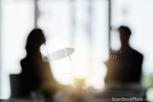 Image of Silhouette, blur and business people in meeting in office for discussion, planning and conversation. Corporate workplace, collaboration and blurred man and woman in conference room for partnership