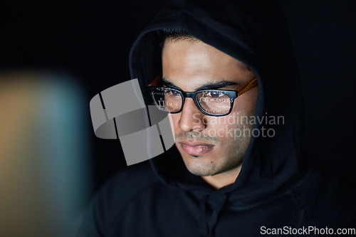 Image of Hacking, computer and hacker man in hoodie programming, coding software and information technology in dark room. Code analysis, night cybersecurity and programmer or focus person hacking data on pc