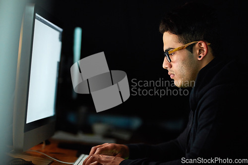 Image of Computer, typing and man at night for software development, programming update and information technology. Focus, research and geek or programmer person on desktop screen for website cyber security