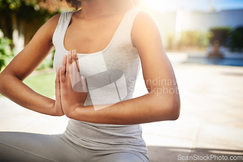 Image of Woman, hands and yoga in meditation for mindfulness, zen or spiritual wellness on floor mat outdoors. Hand of calm female yogi meditating for peaceful mind and awareness for healthy mental wellbeing