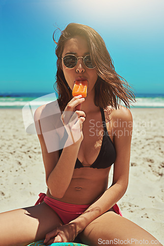 Image of Ice cream, beach swimsuit and woman portrait on holiday by the sea and blue sky with happiness. Sun, sand and young female person face with eating and lens flare by the ocean in summer on vacation