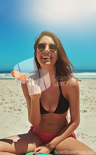 Image of Ice cream, beach smile and woman portrait on holiday by the sea and blue sky with happiness. Sun, sand and young female person face with a happy travel and lens flare by ocean in summer on vacation