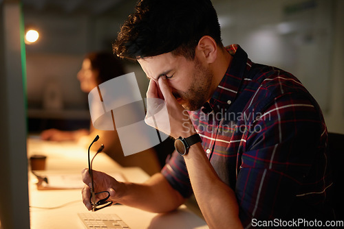 Image of Stress, headache and burnout with a man programmer working on a computer in his office for design. Tired, 404 and deadline with a male employee working on system code for software development