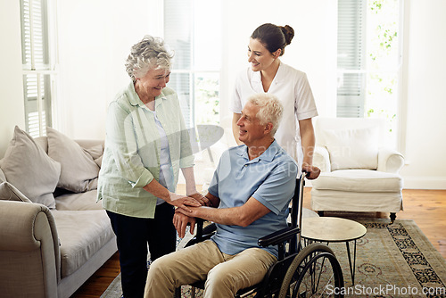 Image of Smile, old man in wheelchair with wife and nurse at nursing home for disability help and rehabilitation. Healthcare, disability and happy senior couple with caregiver in living room for elderly care.