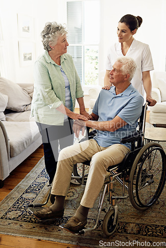 Image of Support, old man in wheelchair with wife and nurse at nursing home for help with disability and rehabilitation. Healthcare, disability and senior couple with caregiver in living room for elderly care