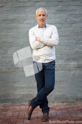 Image of Portrait, business and mature man with arms crossed, entrepreneur and confident guy against a brick wall. Face, male person and employee with startup success, formal and professional with a career