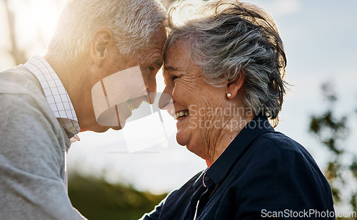 Image of Love, nature and senior couple intimate or face together and outdoors or happy in retirement. Mature, man and woman forehead smile in vacation or senior citizens care and embrace date at the park.