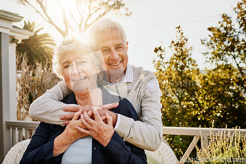 Image of Hug, patio and portrait of senior couple at sunrise enjoy bonding, quality time and relax in morning. Love, retirement home and face of elderly man and woman smile for marriage, trust and happiness