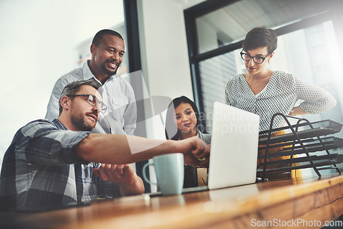 Image of Collaboration, laptop and review with business people in meeting for project management, coaching or planning. Technology, website and training with group of employees in office for teamwork and idea