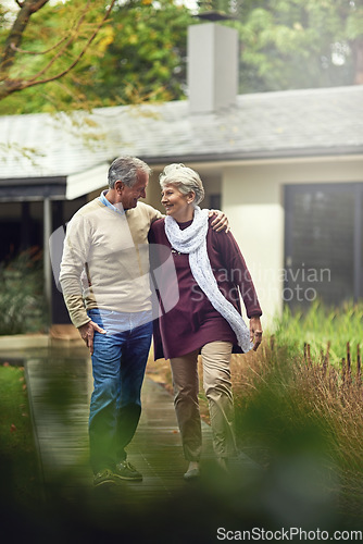 Image of Conversation, love and elderly couple walking in their garden by the house for wellness and fresh air. Bonding, retirement and senior man and woman on path together in their backyard at modern home.