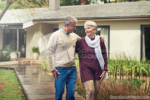 Image of Love, garden and senior couple walking by their house for wellness, fresh air and bonding. Happy, retirement and elderly man and woman on a path together in their garden at their modern home.