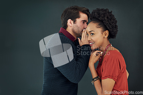 Image of Business, man and woman with gossip, news and speaking against a dark studio background. Female person, happy male employee and staff with discussion, secret and privacy with trust, chat and story