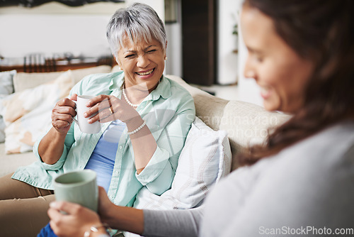 Image of Laugh, coffee and mother with daughter on sofa in living room for bonding, conversation and happiness. Smile, chat and discussion with women talking in family home for generations, reunion and break