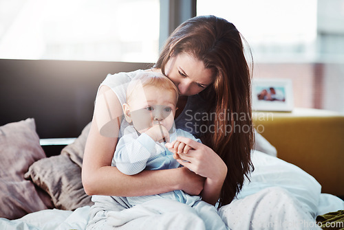 Image of Mother, baby and hug in bed with love or bedroom, peace in morning and newborn together, relax and calm mom in home. Postpartum, boy and quality time with mama to enjoy, support or care for child