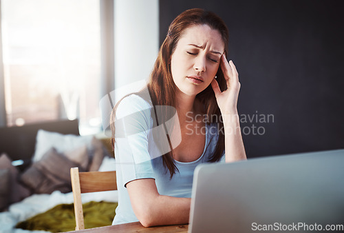 Image of Stress, remote work and woman with a headache working on a freelance project with a laptop. Burnout, sick and female freelancer with a migraine in pain doing research at her desk or workspace at home