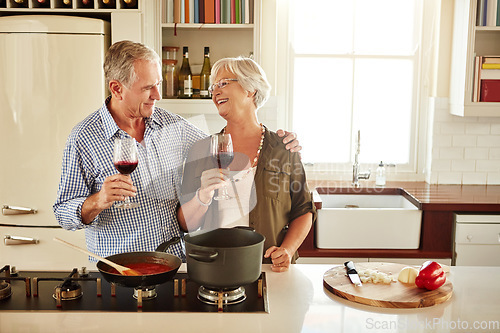 Image of Love, wine or happy old couple cooking food for a healthy diet together with love in retirement at home. Hugging or happy senior woman laughing or drinking in kitchen with mature husband at dinner