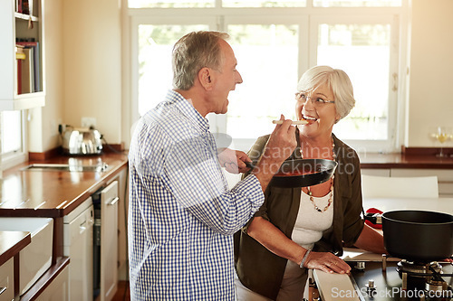 Image of Taste, happy or old couple kitchen cooking with healthy food for lunch or dinner together at home in retirement. Senior woman tasting or smiling with mature husband in meal preparation in Australia