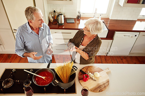 Image of Top view, speaking or old couple in kitchen cooking with healthy vegetables for lunch meal or dinner together. Senior woman helping or talking to mature husband in food meal preparation in retirement