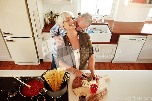 Image of Kiss, hug or old couple cooking food for a healthy vegan diet together with love in retirement at home. Smile, romance or elderly husband kissing or hugging senior woman in house kitchen at dinner