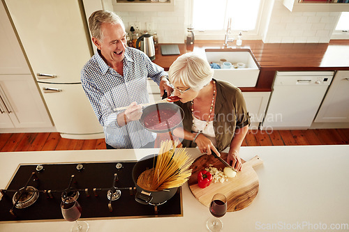 Image of Top view, taste or old couple kitchen cooking with healthy food for lunch or dinner together at home. Love, help or senior woman tasting or eating with mature man in meal preparation in retirement