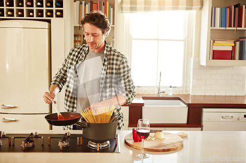 Image of Food, cooking or mature man in kitchen with healthy vegan diet for nutrition or wellness at home in Australia. Wine glass, spaghetti or male person in house kitchen in preparation for dinner meal