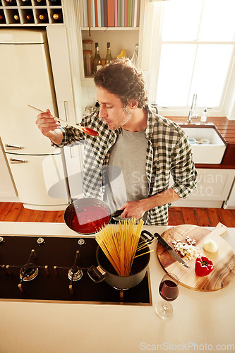 Image of Food, cooking or man tasting in kitchen with healthy vegan diet for nutrition or vegetables at home in Italy. Spaghetti sauce taste, above or person in house kitchen in preparation for dinner meal